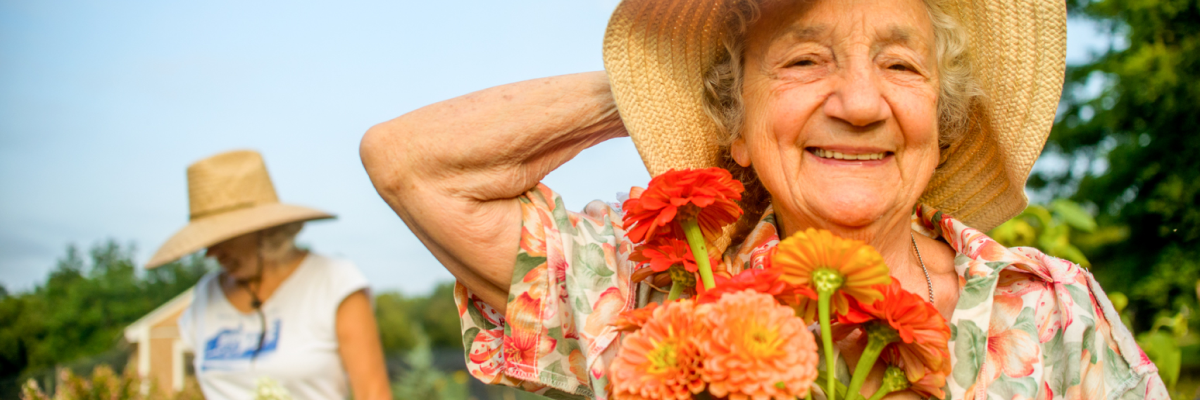 Smiling old woman with flowers